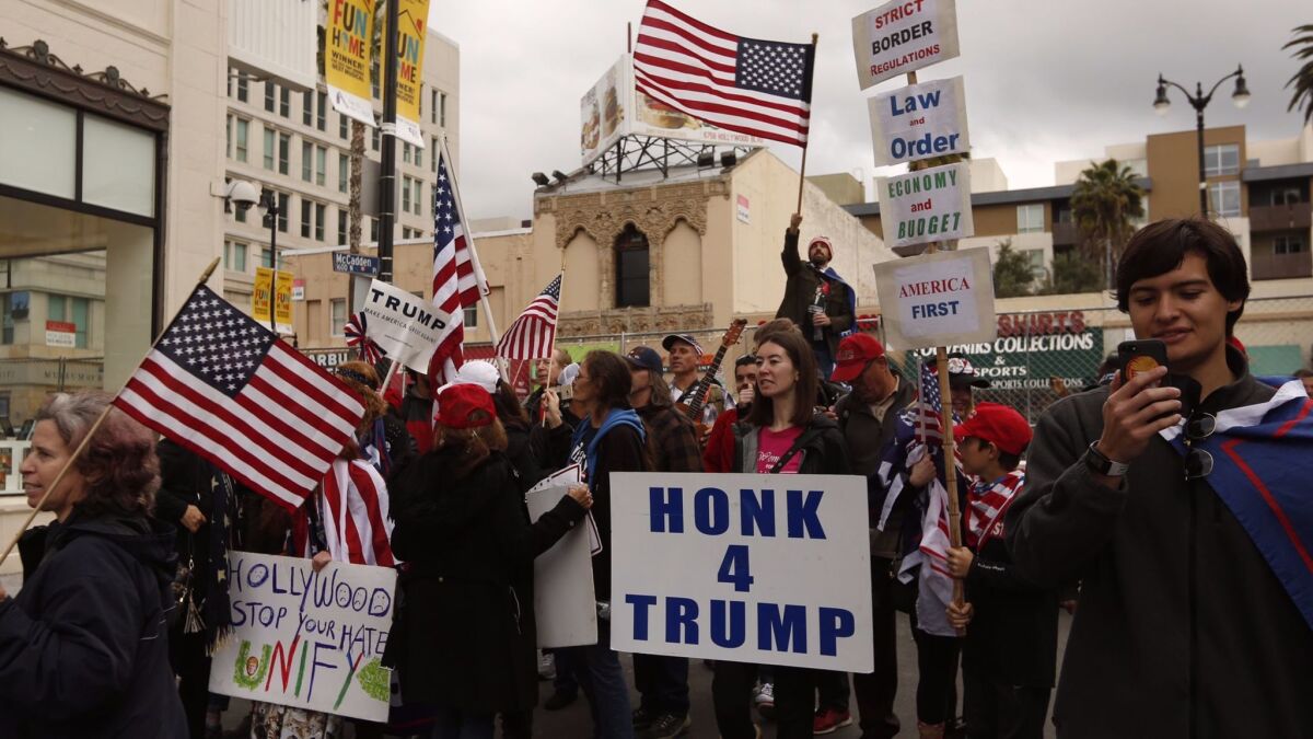 Members of the group San Fernando Valley For Trump Celebration and others rally near the Dolby Theatre in support of the president.