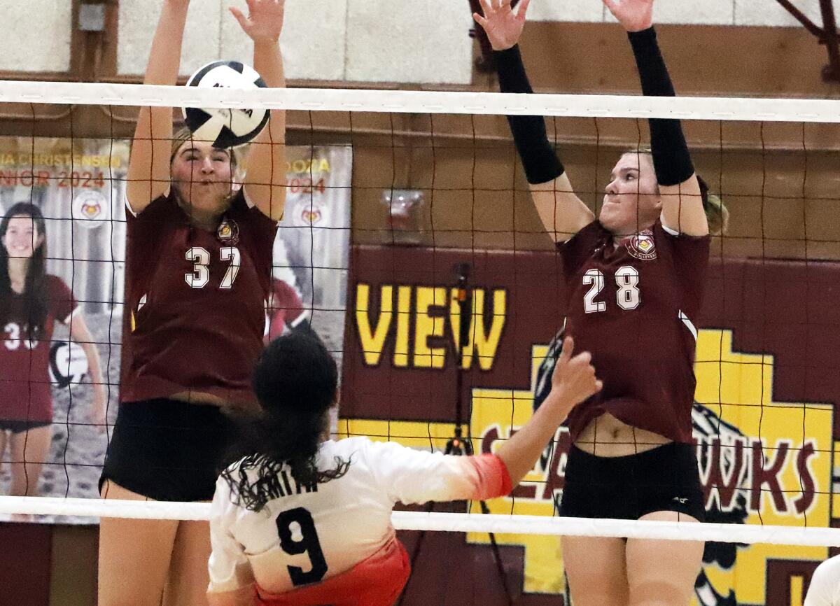 Ocean View's Charlotte Johnson (37) and Jade Auger (28) try to block Westminster's Annalee Smith's (9) spike on Wednesday.