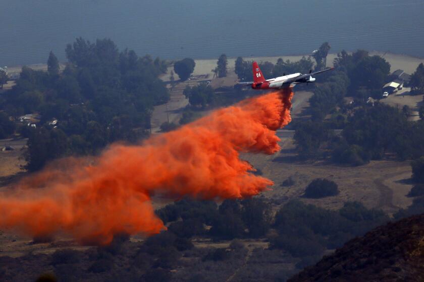 The air assault continued Tuesday morning to contain the 1,500-acre Falls fire near Lake Elsinore.