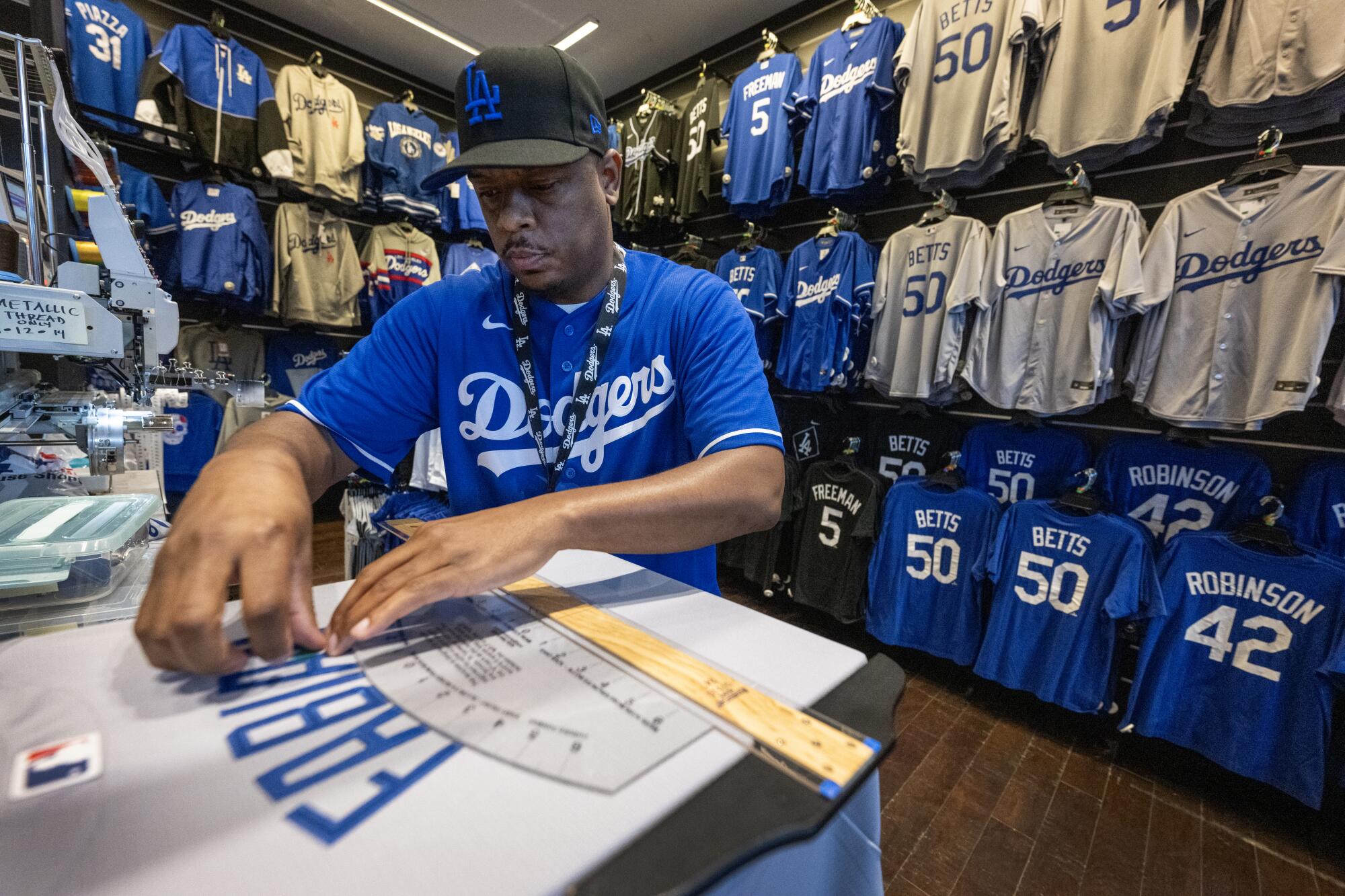 A Dodgers Clubhouse store manager makes a custom jersey.