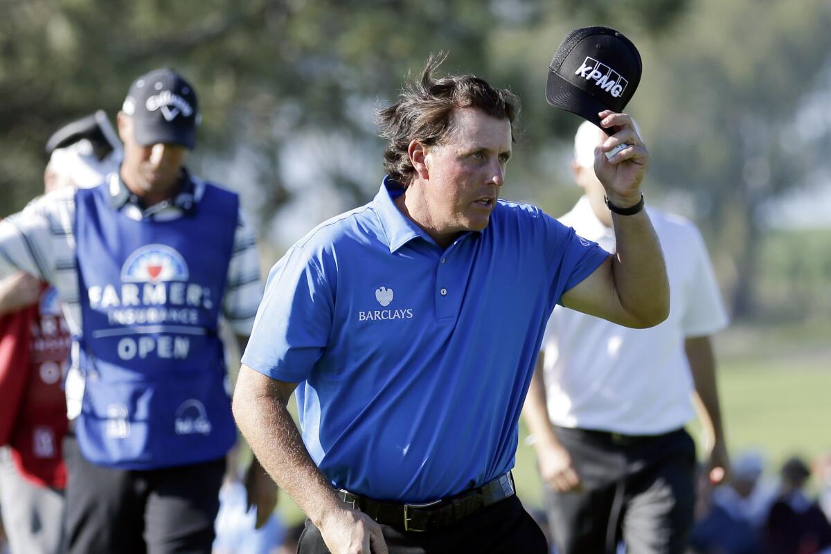 Phil Mickelson acknowledges the cheers from the crowd after finishing the second round of the Farmers Insurance Open at Torrey Pines' North course on Friday.