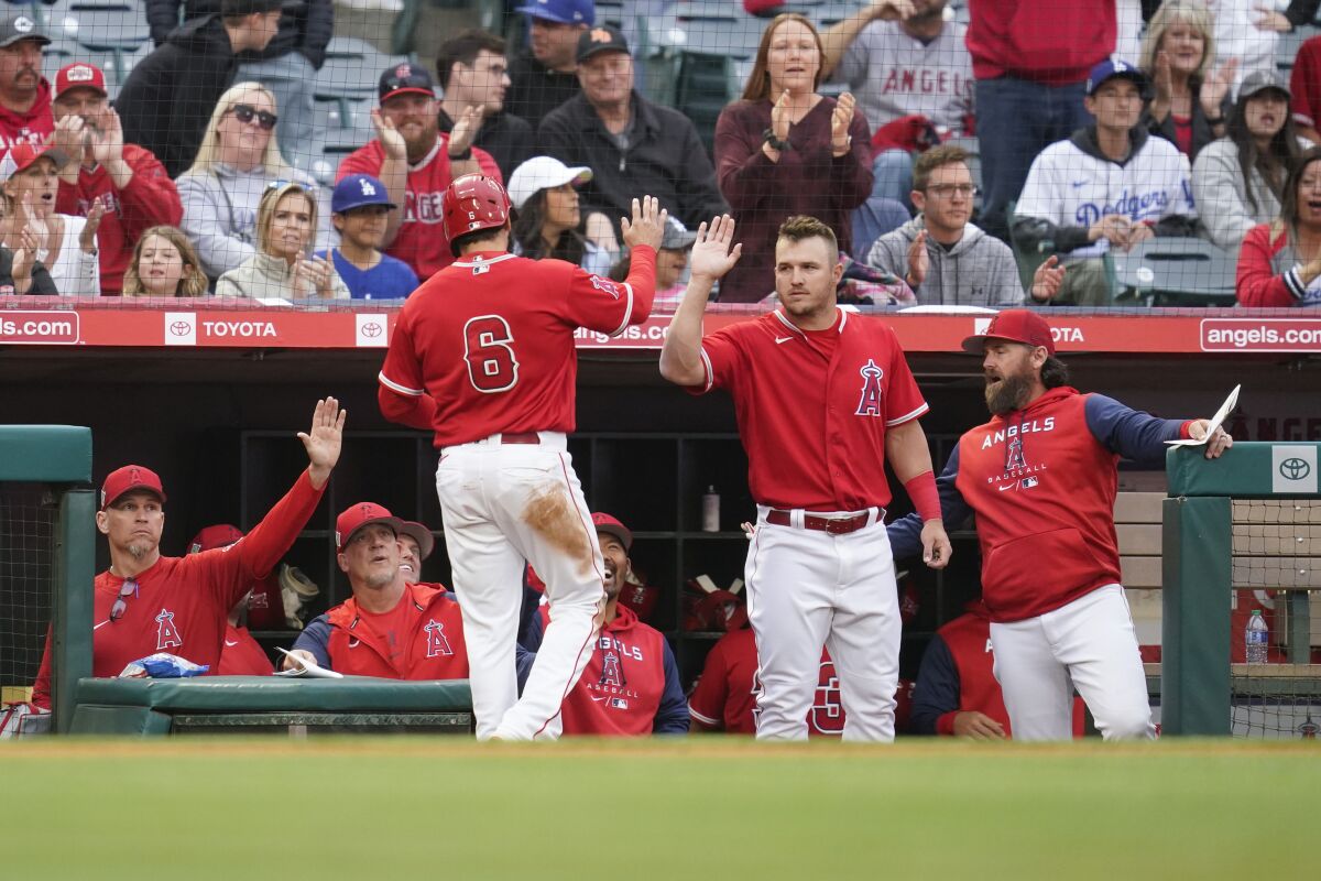 Angels' Anthony Rendon celebrates with Mike Trout after scoring.
