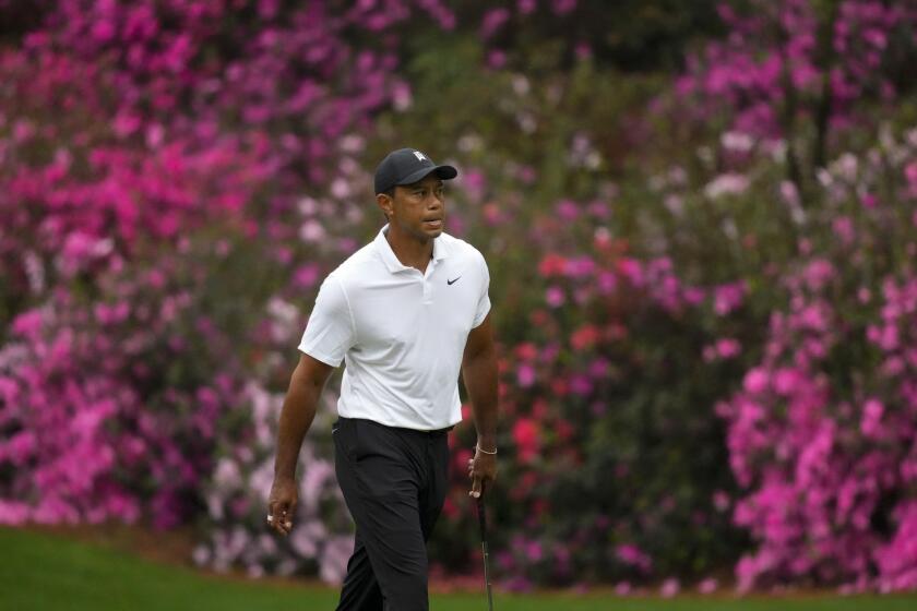 Tiger Woods walks to the 13th green during a practice round for the Masters golf tournament on Wednesday, April 6, 2022, in Augusta, Ga. (AP Photo/Charlie Riedel)