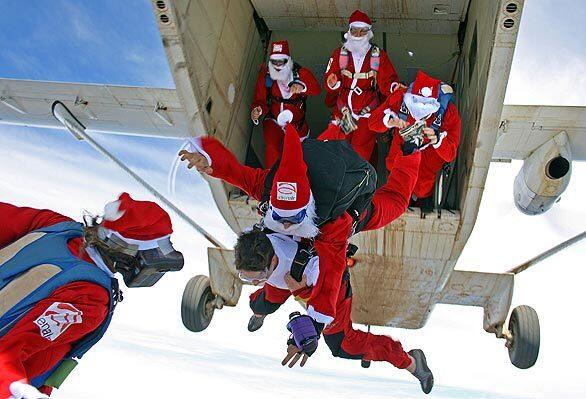 Thrill-seeking Santa Clauses jump from a Short-Skyvan while skydiving at Picton in the Southern Highlands in Australia.