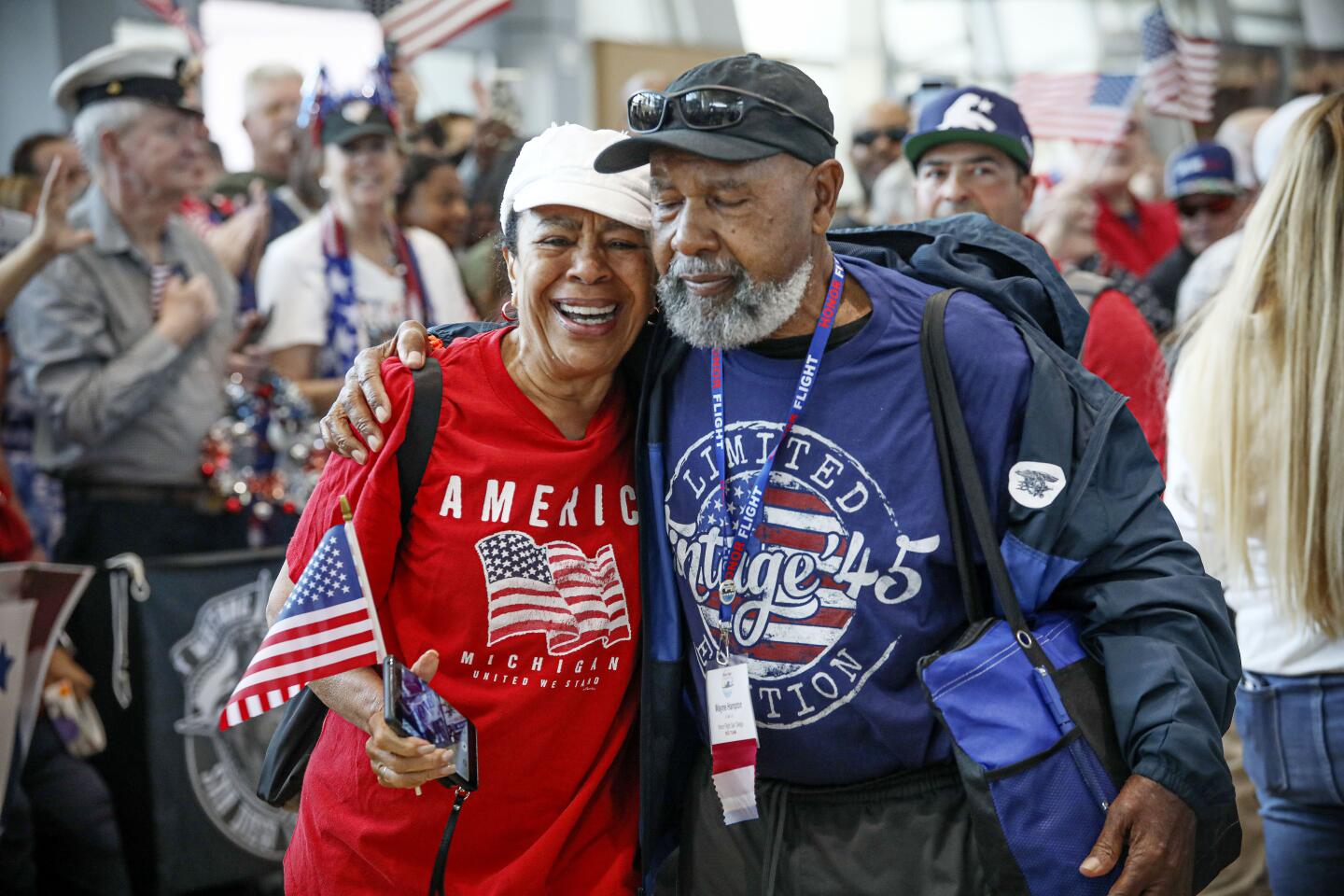 Navy Veteran Wayne Hampton greets supporters with his wife Diane after arriving back in San Diego from an Honor Flight tour, at the San Diego International Airport on Sunday, April 28, 2024.