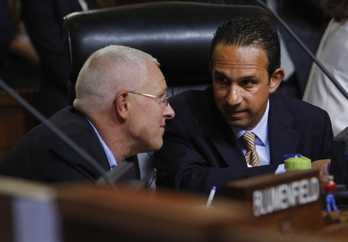 Los Angeles City Councilman Mitch Englander, right, confers with Councilman Mike Bonin during a June 2015 meeting.
