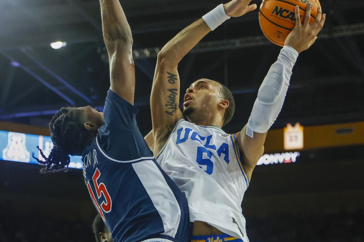 UCLA guard Amari Bailey (5) shoots against Arizona guard Cedric Henderson Jr. (45)