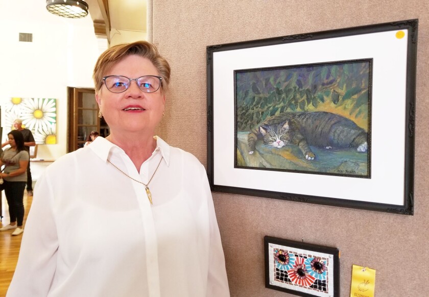 Judy Jacobs, president of the San Diego Chapter of the Colored Pencil Society of America, with her drawing of a cat.