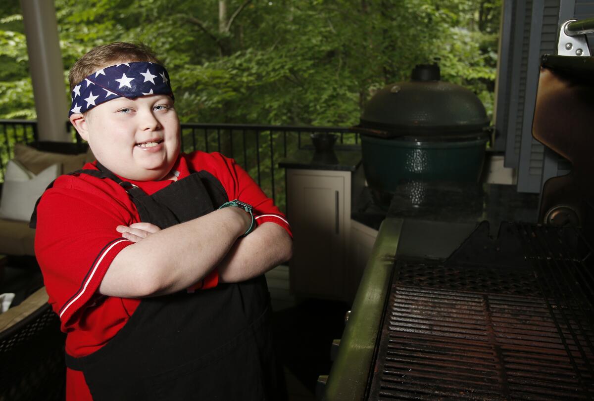 Fuller Goldsmith stands at one of three grills on his back porch in Tuscaloosa, Ala., in 2017.