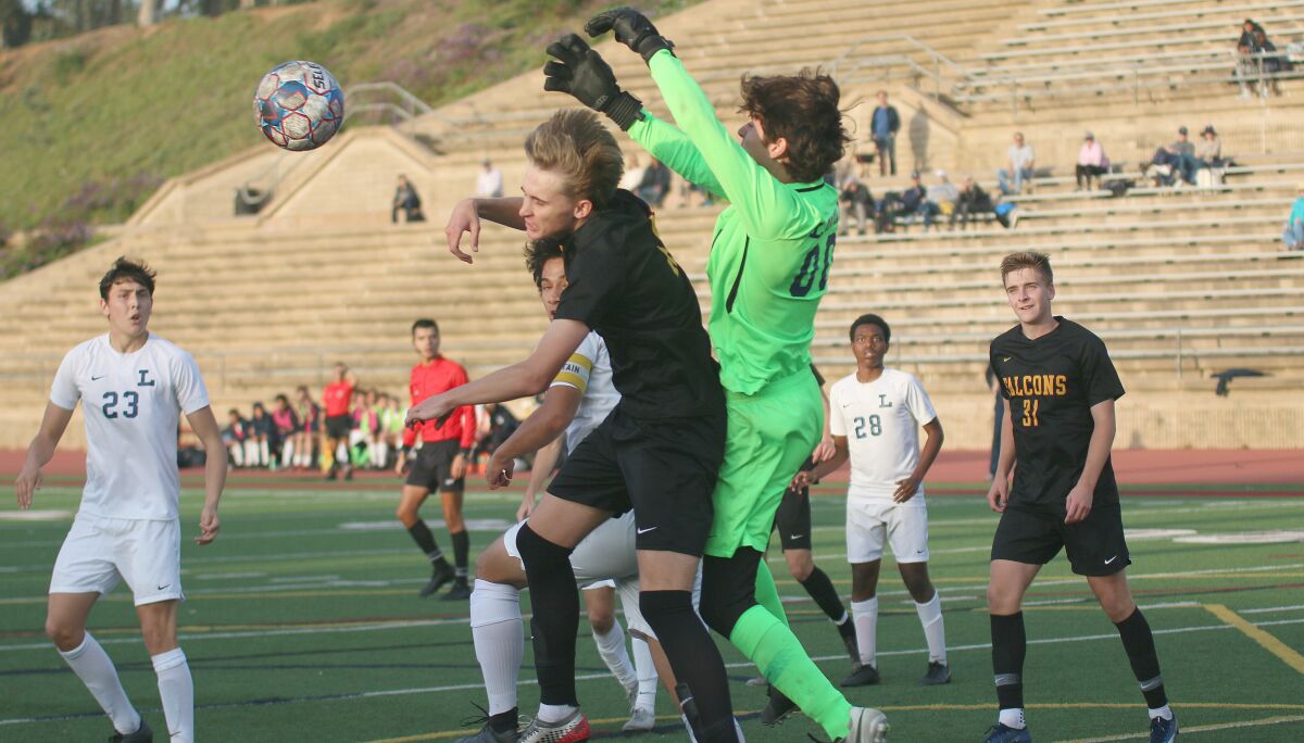Torrey Pines defender Zach Lesher gets airborne in front of the Loyola net.