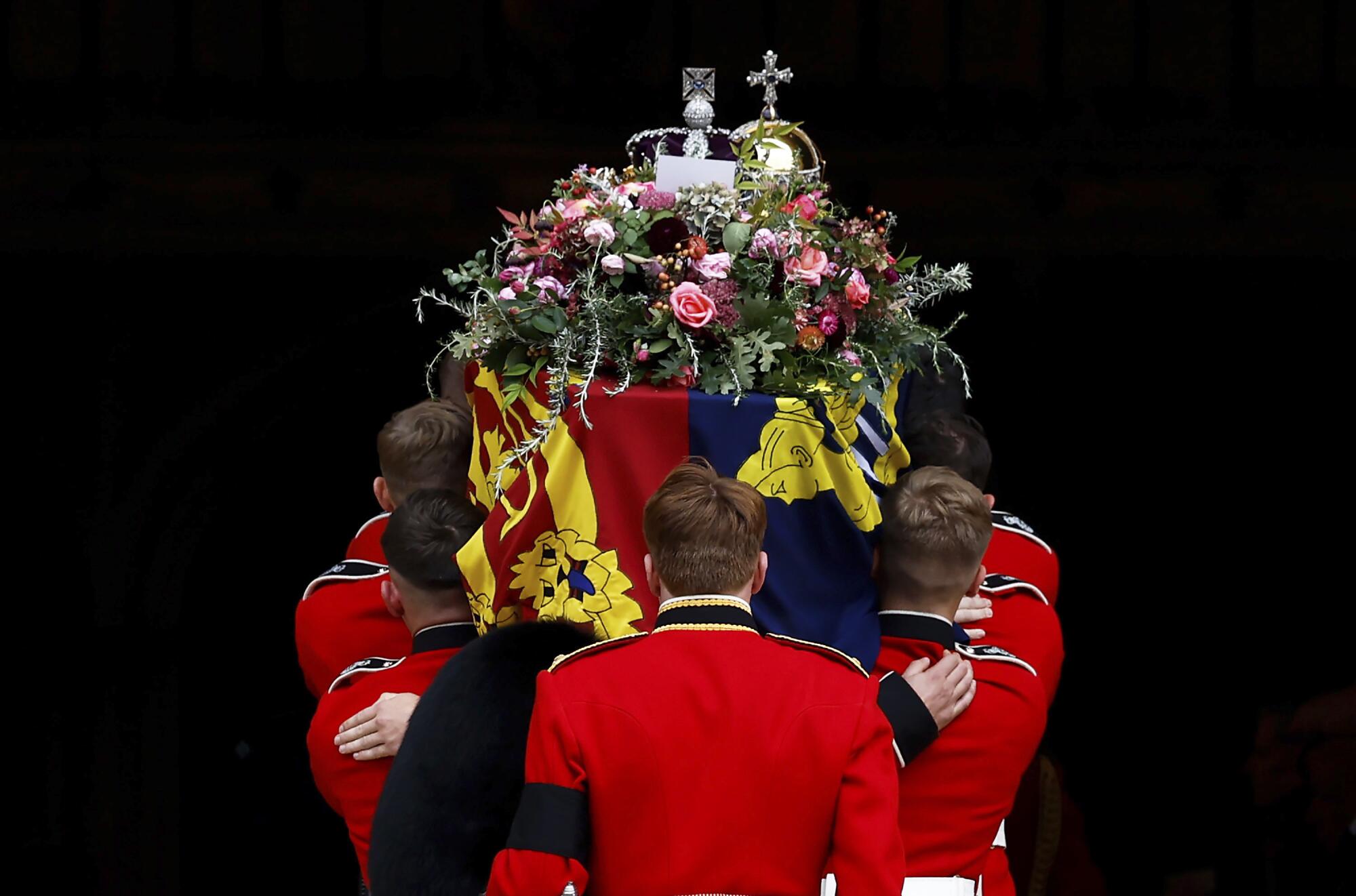 Pall bearers carry the coffin of Queen Elizabeth II.