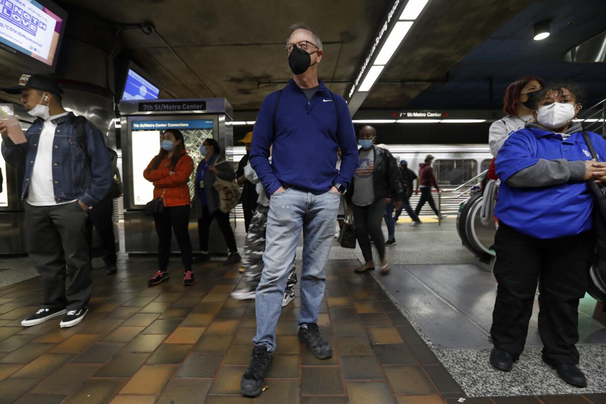 A man waits on the platform at a Metro station in downtown Los Angeles.
