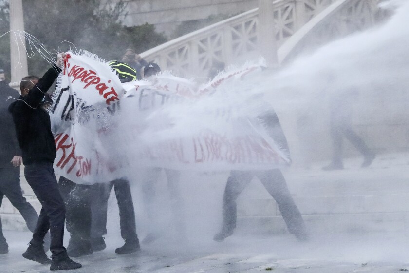 Police use a water cannon against protesters who demonstrate in support of Dimitris Koufodinas, a leading member of the armed extreme-left group November 17 who is on hunger strike, on Friday, March 5, 2021. A hospital in central Greece says the far-left militant convicted of 11 murders is in critical condition after suffering kidney failure following 56 days of hunger strike. (John Liakos/InTime News via AP)