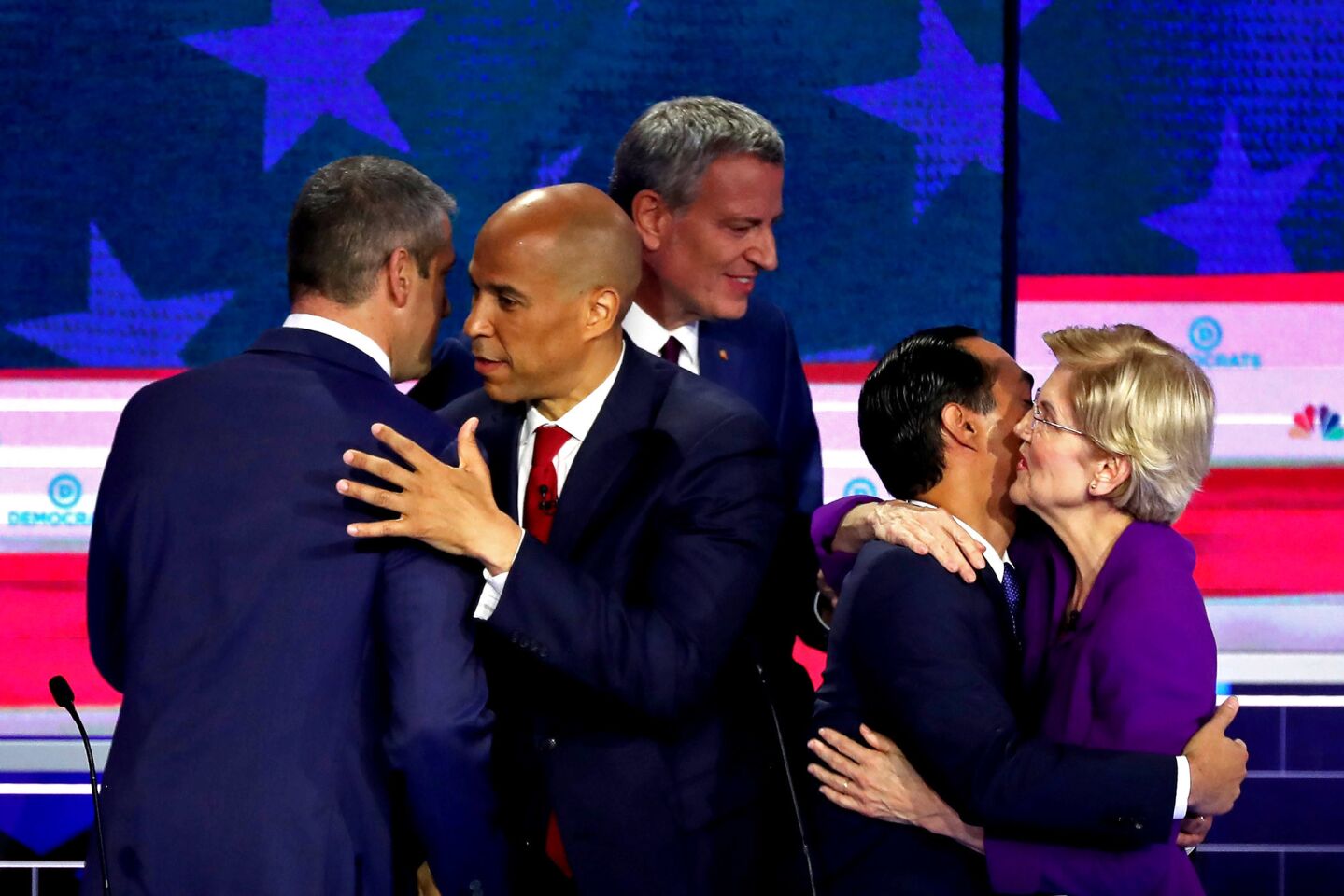 Rep. Tim Ryan (D-OH), Sen. Cory Booker (D-NJ), New York City Mayor Bill De Blasio, former housing secretary Julian Castro and Sen. Elizabeth Warren (D-MA) embrace after the first night of the Democratic presidential debate on June 26, 2019 in Miami, Florida. A field of 20 Democratic presidential candidates was split into two groups of 10 for the first debate of the 2020 election, taking place over two nights at Knight Concert Hall of the Adrienne Arsht Center for the Performing Arts of Miami-Dade County, hosted by NBC News, MSNBC, and Telemundo.