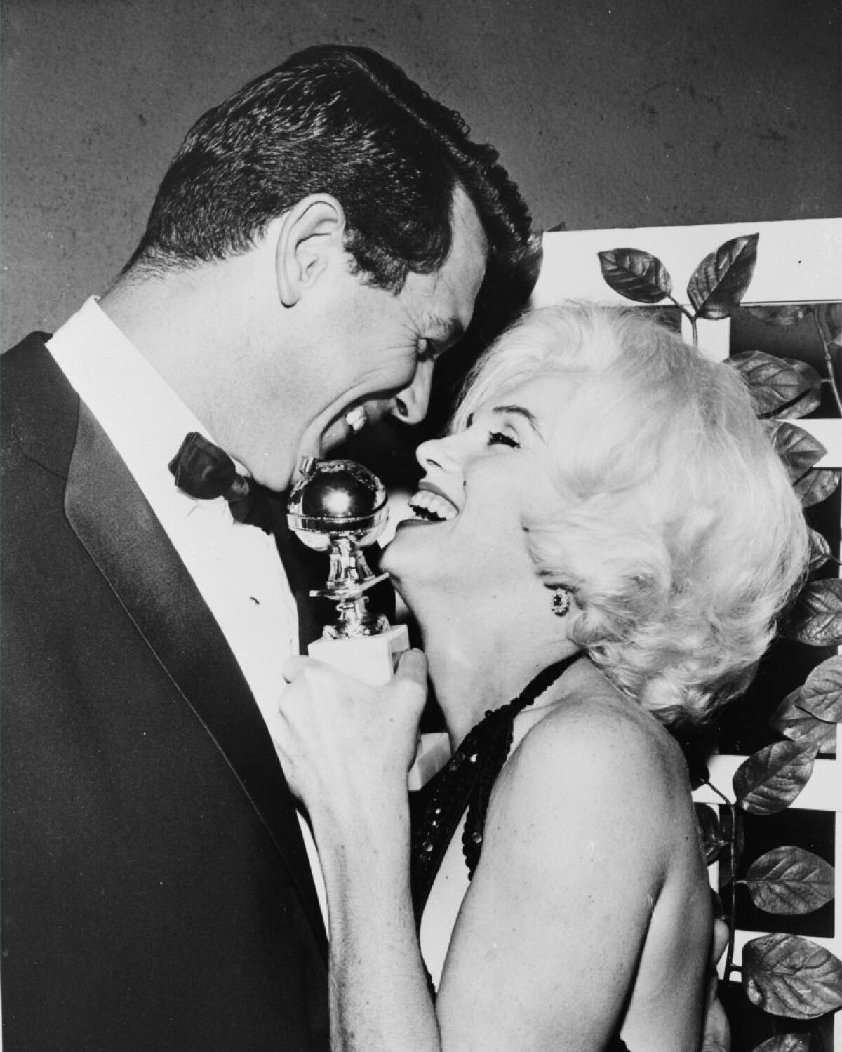 Marilyn Monroe receives her Golden Globe award from Rock Hudson at the Beverly Hilton in 1962.