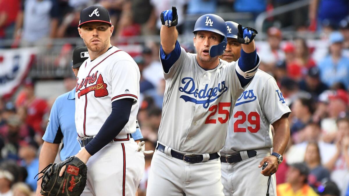Dodgers' David Freese points to the bench after hitting a two-run single against the Braves in the sixth inning in Game 4 of the NLDS in Atlanta on Oct. 8, 2018.