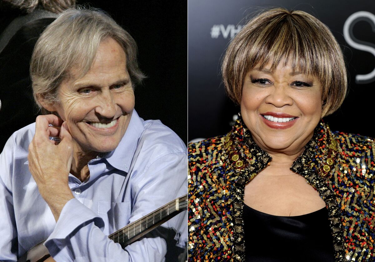 Singer Levon Helm appears on the new "Imus in the Morning" program in New York on Dec. 3, 2007, left, and singer Mavis Staples appears at the "Vh1 Divas Celebrates Soul" in New York on Dec. 18, 2011. An album by the duo “Carry Me Home," releases this week. (AP Photo)