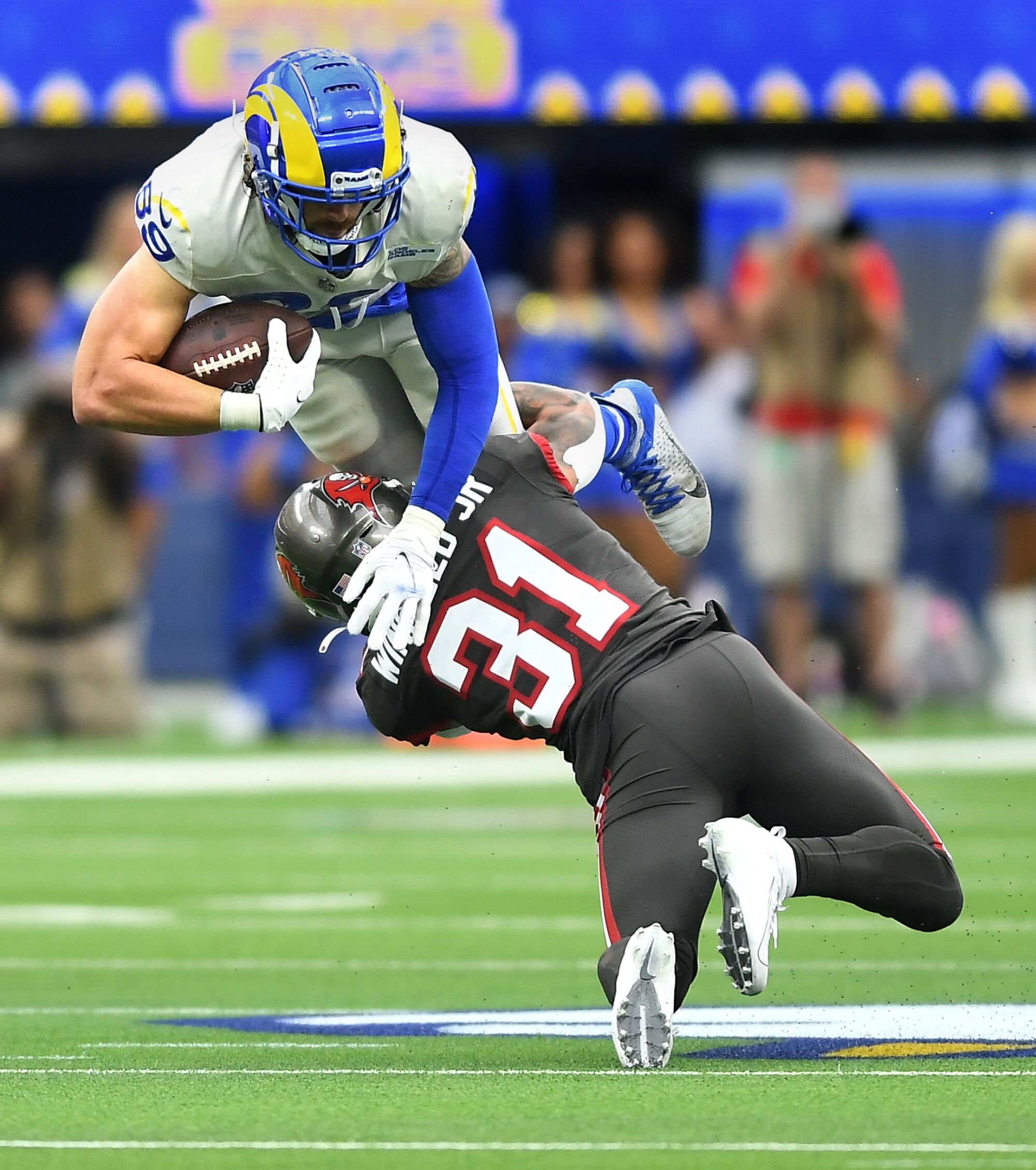Rams tight end Tyler Higbee is upended by Buccaneers safety Antoine Winfield.