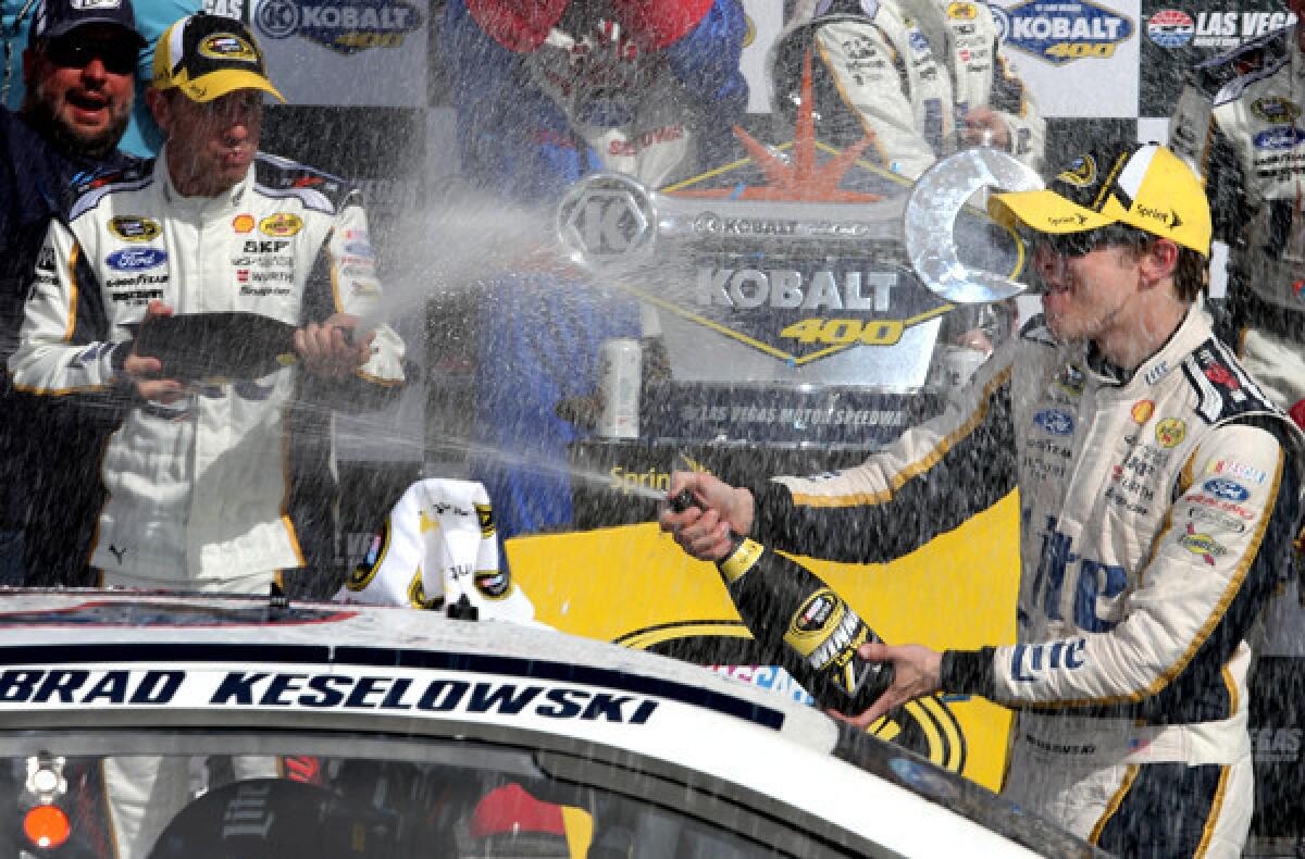 NASCAR driver Brad Keselowski celebrates with crew member after winning the Sprint Cup Series Kobalt 400 at Las Vegas Motor Speedway on Sunday.