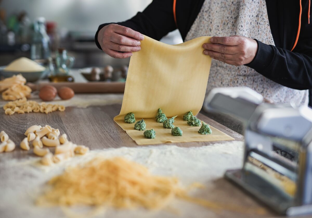 Preparing fresh made ravioli with ricotta cheese.