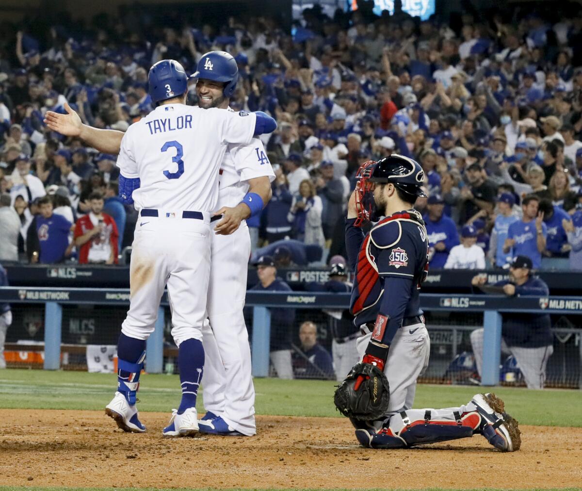 Chris Taylor gets a hug from Albert Pujols after his home run in the fifth inning.