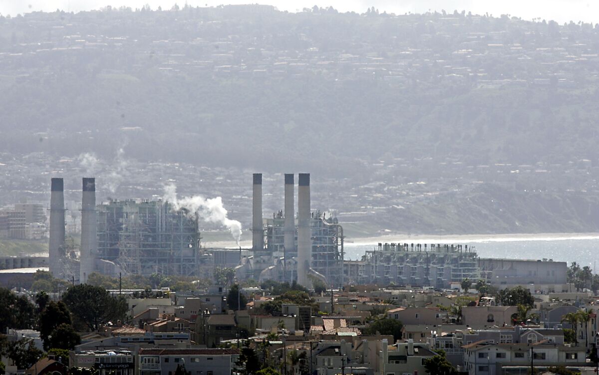 An aerial view of an AES power plant, with its smokestacks rising near the shore in Redondo Beach.