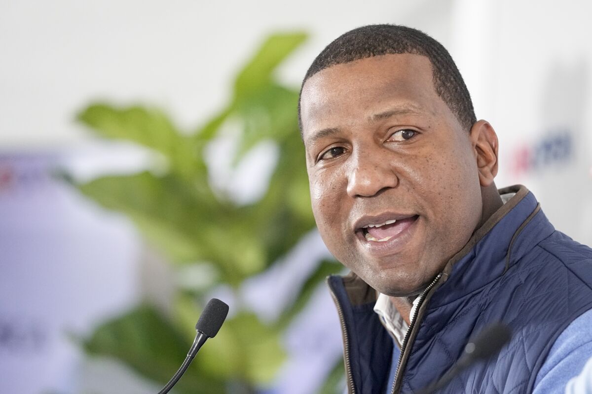 USGA President Fred Perpall speaks into a microphone and glances up during a news conference