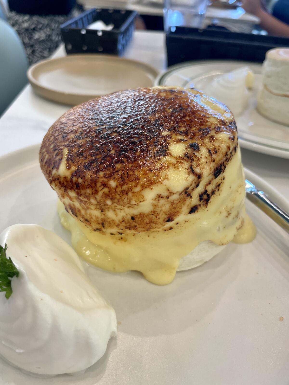 A stack of thick creme brulee pancakes with custard.