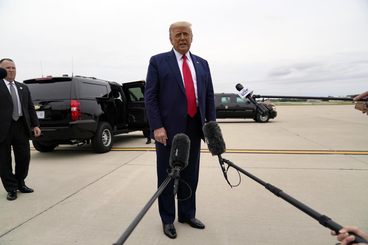 President Trump talks to reporters while traveling to Kenosha, Wis., on Tuesday.