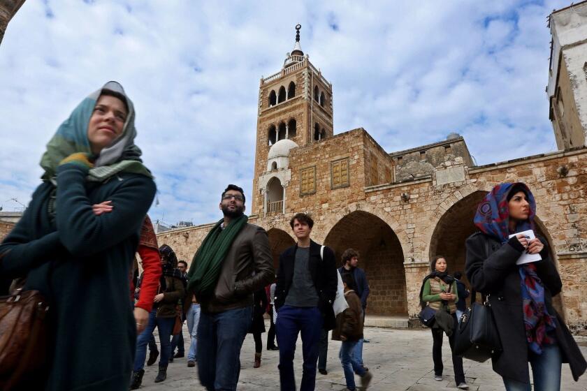 Tourists visit the Great Mosque in Tripoli, Lebanon, in 2015.