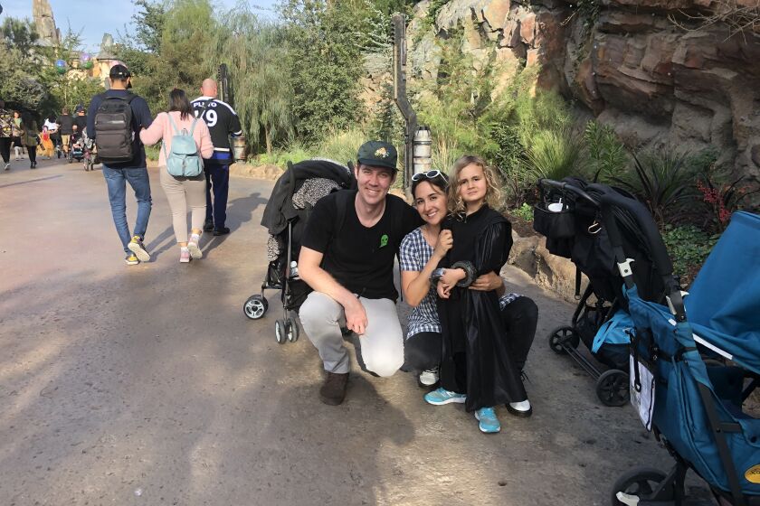 Josh Graves, 33, pictured left, Gabrielle Graves, 30, and their 4-year-old son, Will Graves, visit Star Wars' Galaxy Edge in Disneyland in Anaheim. The Graves said they weren't going to let the coronavirus outbreak stop them from going to Disneyland. They said they took precaution by washing their hands, using hand sanitizers and wiping down tables before eating.