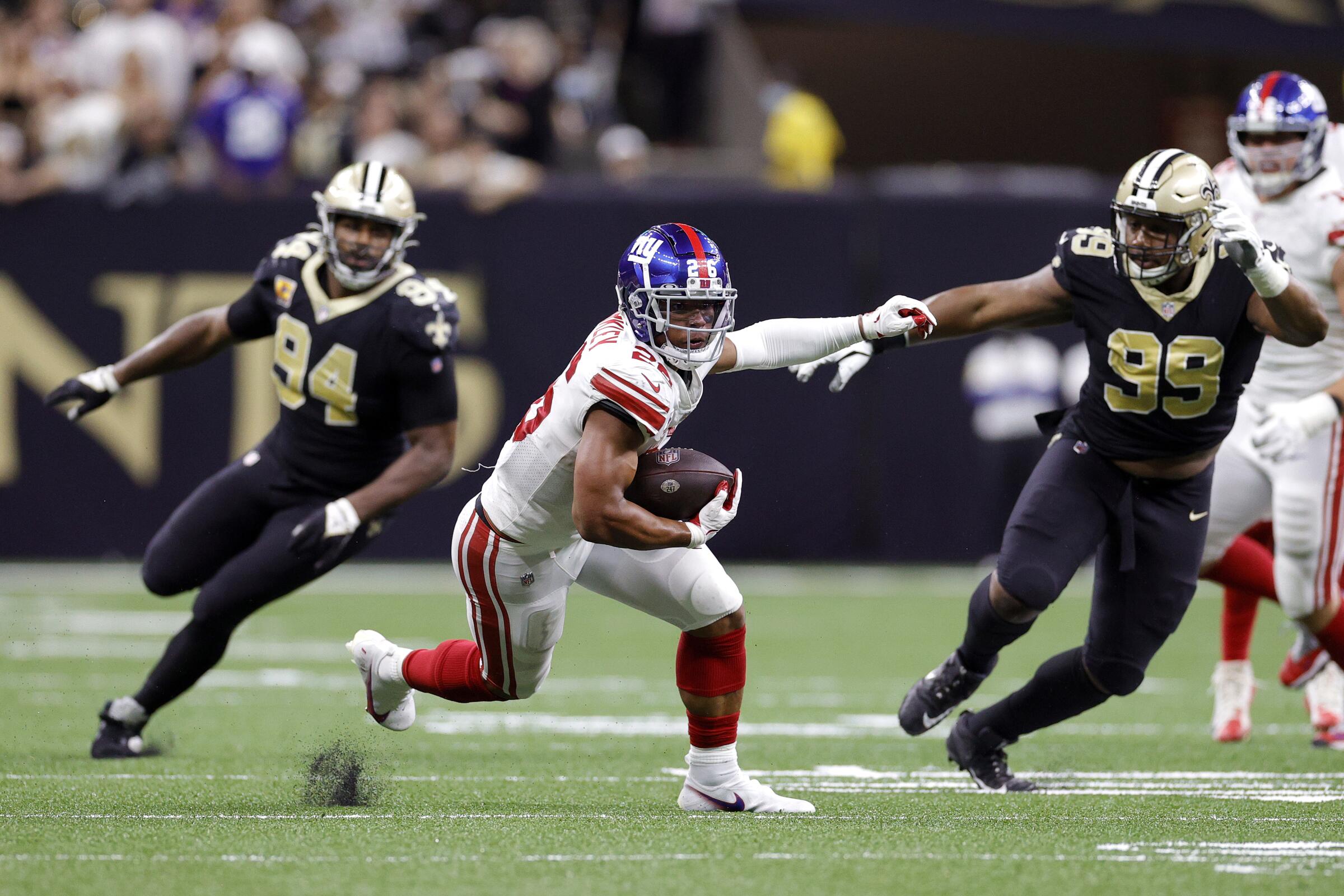 New York Giants running back Saquon Barkley carries the ball against the New Orleans Saints.