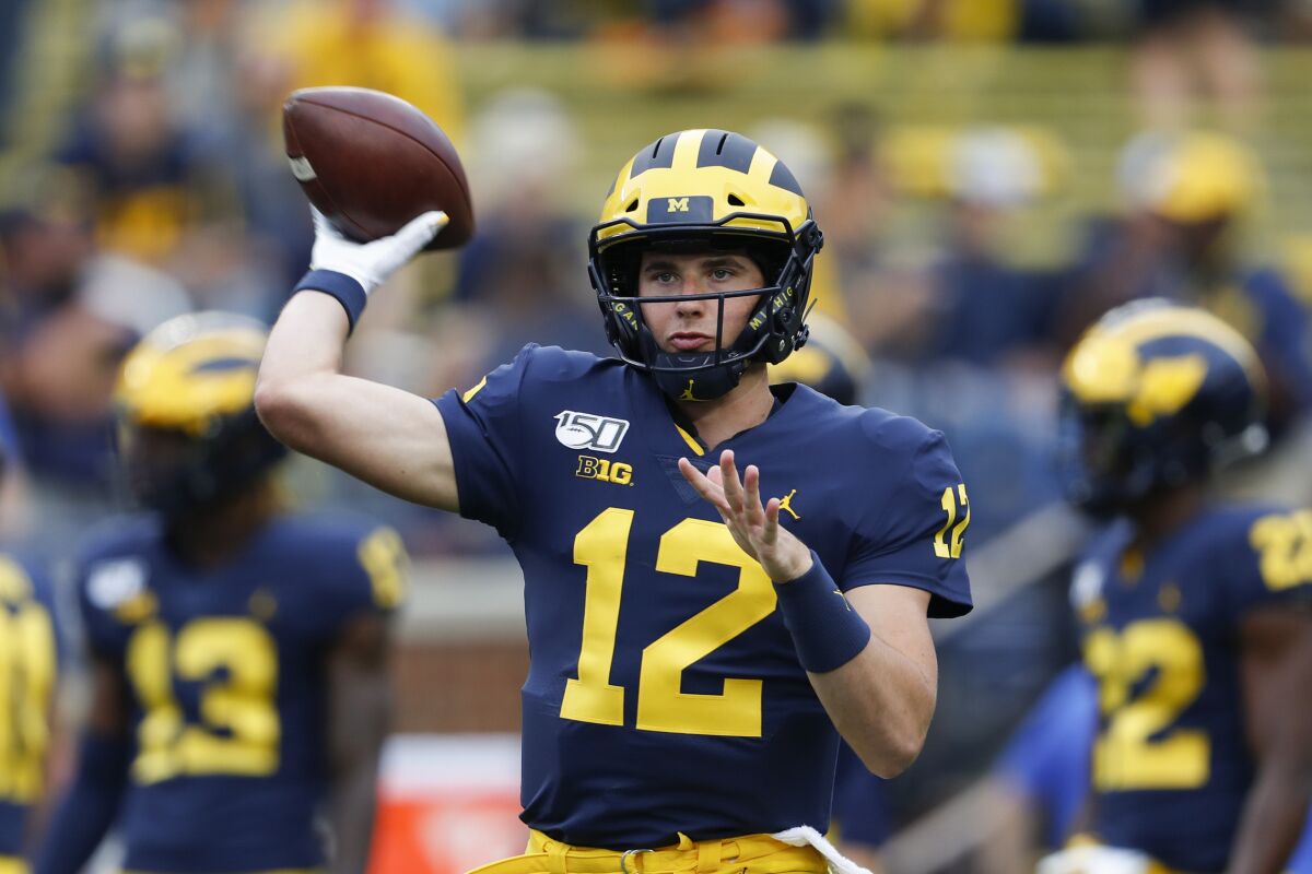 FILE - In this Aug. 31, 2019, file photo, Michigan quarterback Cade McNamara throws during warmups before an NCAA college football game against Middle Tennessee in Ann Arbor, Mich. McNamara is expected to start at quarterback this season for the Wolverines. (AP Photo/Paul Sancya, File)