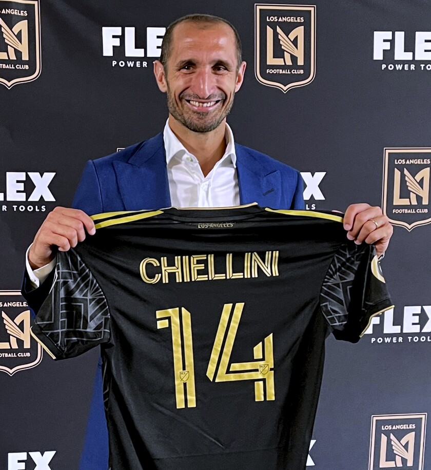 Giorgio Chiellini holds up his jersey in Los Angeles on Wednesday, June 29, 2022, during an introductory news conference as a member of Los Angeles FC. Chiellini is coming to the United States and Major League Soccer following 15 years with Juventus in Italy's Serie A. (AP Photo/Joe Reedy)