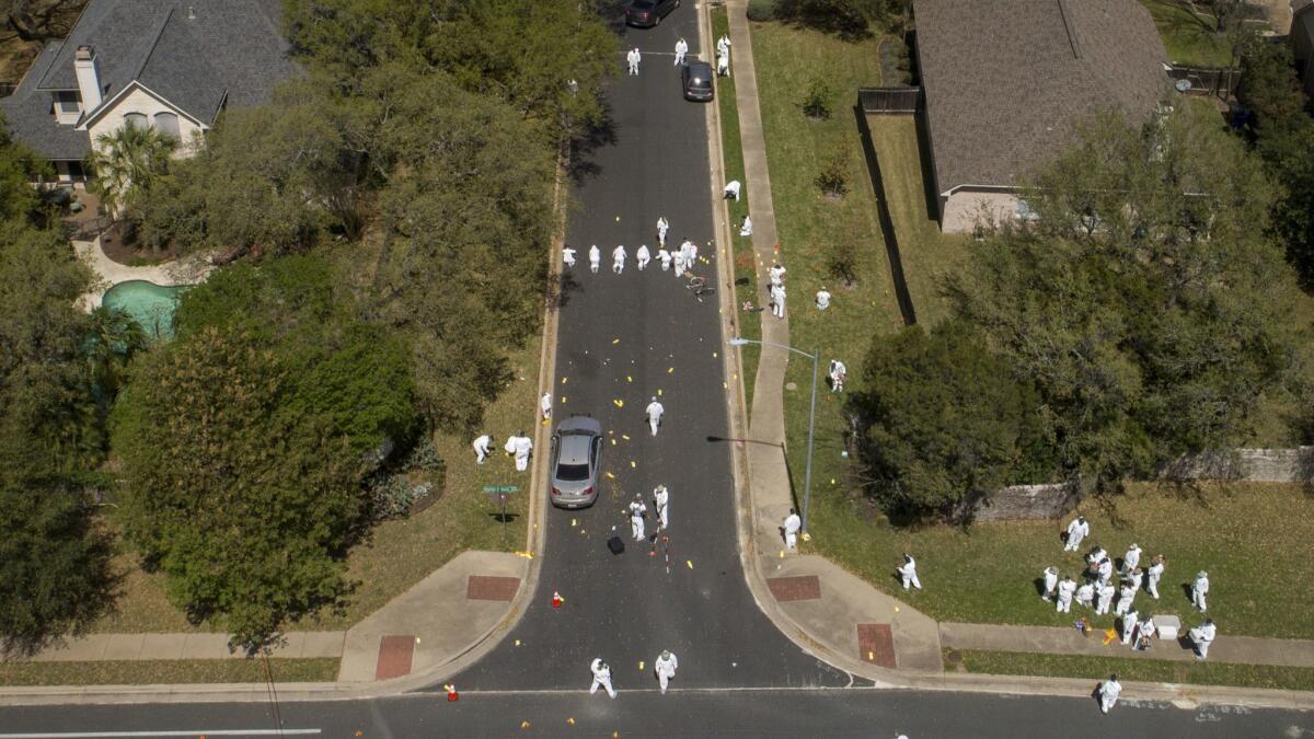 Investigators on March 19, work at the scene of a bomb explosion in Austin, Texas, that seriously injured two men.