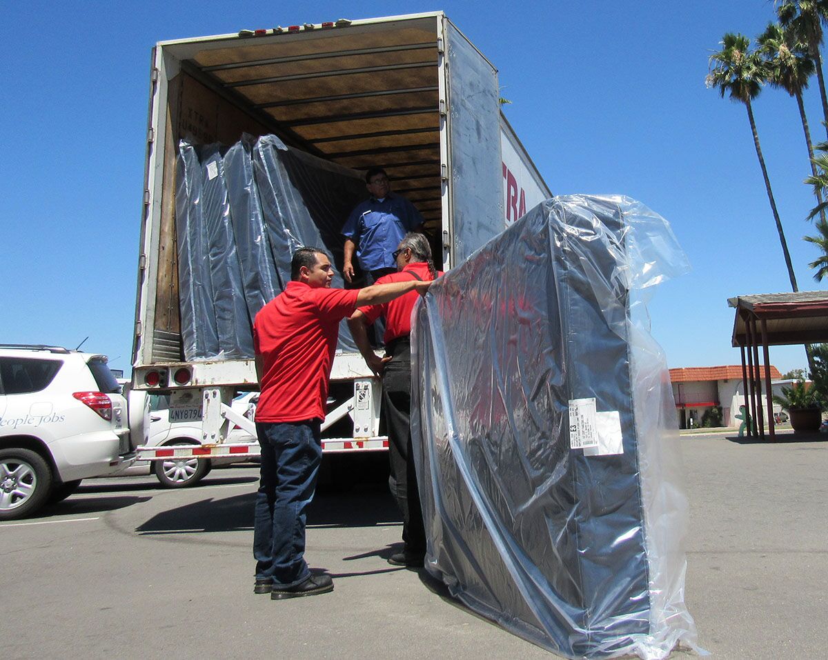 Employees of Jerome's Furniture deliver 60 mattresses to the East County Transitional Living Center in 2017.