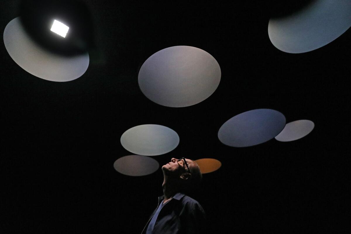 Christian Marclay stands below his installation "Sound Tracks" at LACMA.