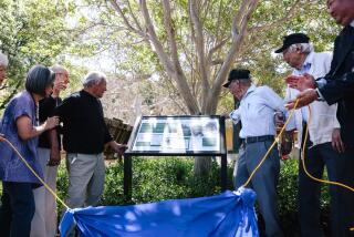 Los Angeles, CA - April 20: A group of honored guests look on during a dedication of an internment camp education sign at the Travel Town Museum in Griffith Park on Thursday, April 20, 2023 in Los Angeles, CA. Griffith Park served as a temporary detention station and held a few hundred Japanese, German and Italians men during World War II. (Dania Maxwell / Los Angeles Times).