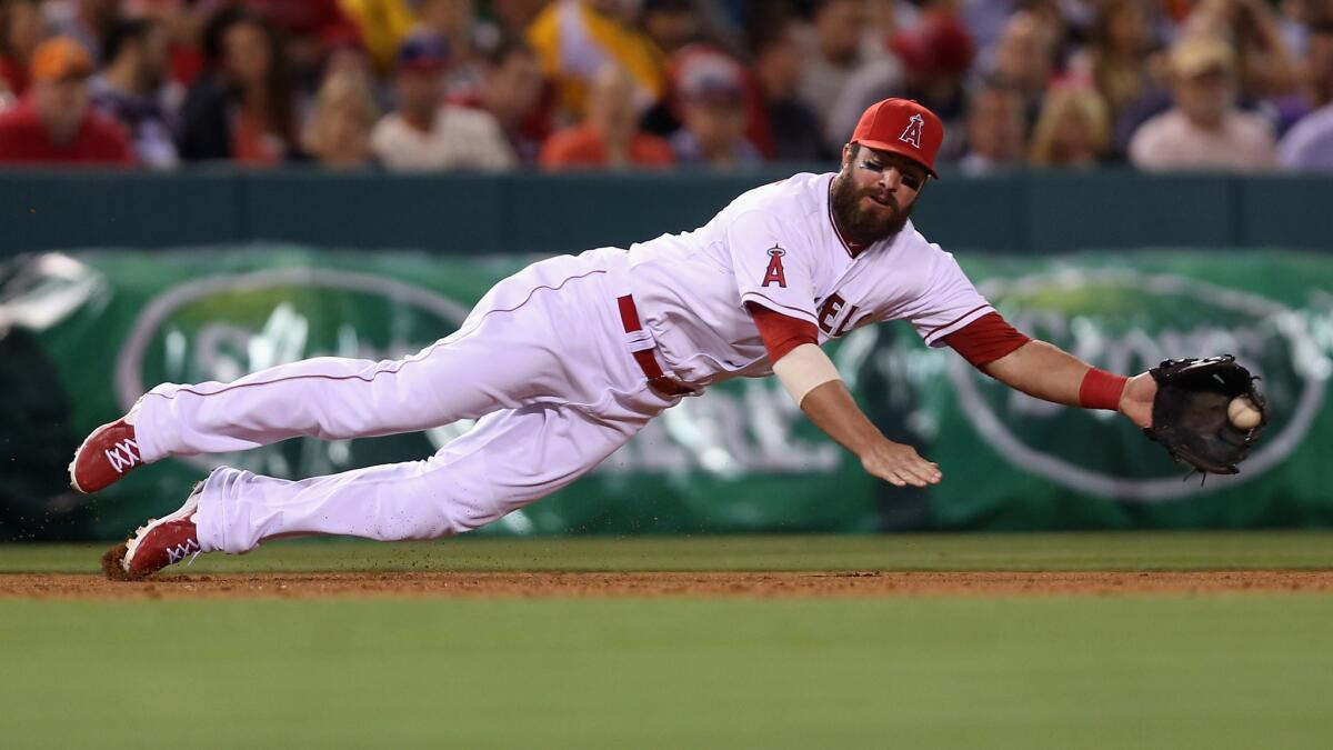 Angels third baseman makes a diving stop on a hit by the Cleveland Indians' Carlos Santana during the Angels' 6-3 win Monday.