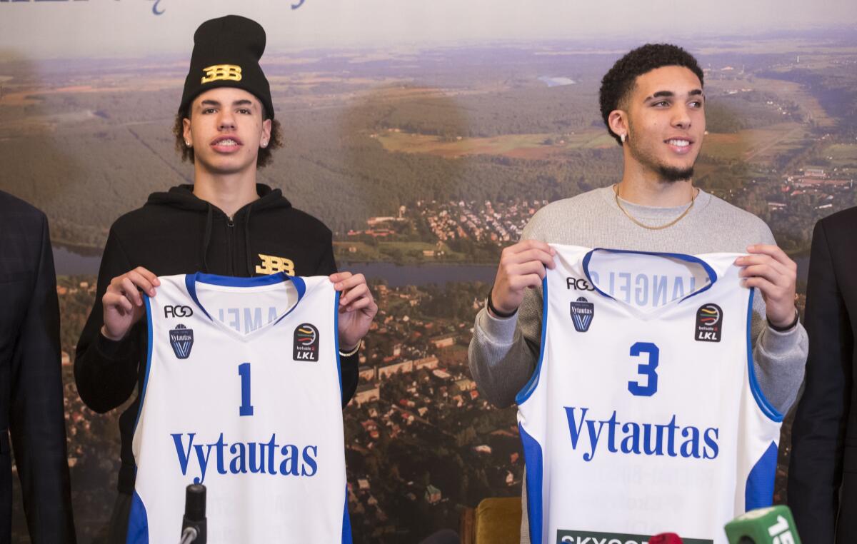 In this Friday, Jan. 5, 2018, file photo, American basketball players LiAngelo Ball, right, and his brother, LaMelo, display their shirts after signing with Lithuanian team BC Prienai - Birstonas Vytautas, during a news conference at the Harmony park hotel in Vaizgaikiemis village, Prienai district, Lithuania. The brothers went scoreless in their pro basketball debut, finishing a combined 0 for 7 on Saturday, Jan. 1,3, 2018.