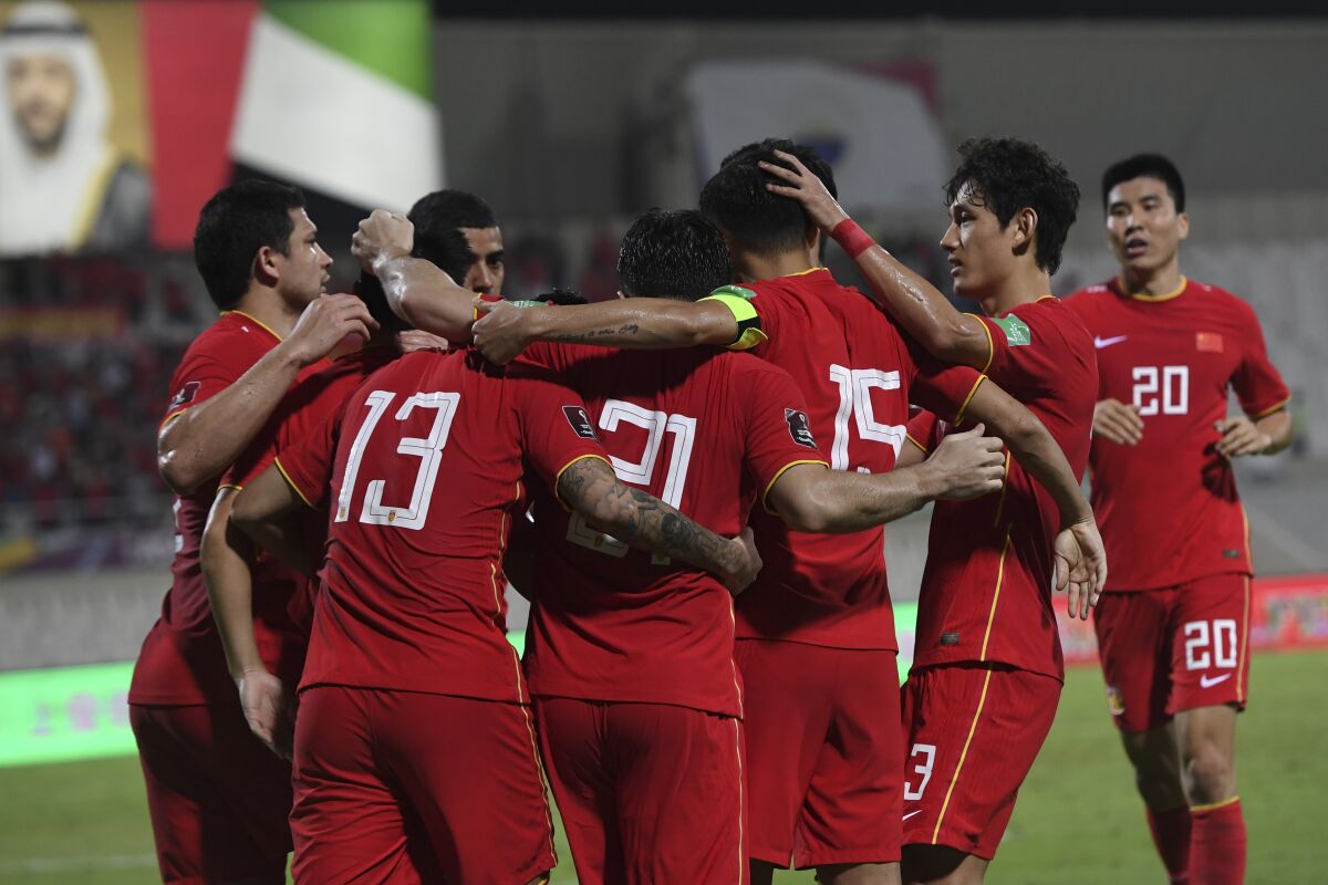 China's players celebrate after a goal during a a qualifying soccer match for the FIFA World Cup Qatar 2022 between China and Australia in Sharjah, the United Arab Emirates, Tuesday Nov 16, 2021. (AP Photo/Martin Dokoupil)