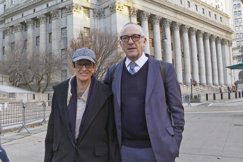 Kevin Maxwell and Isabel Maxwell stand in front of the federal courthouse where their sister Ghislaine Maxwell is on trial for sex trafficking in New York, on Friday, Dec. 3, 2021. The case against Maxwell stems from four now-adult women who said she recruited them into being sexually abused by Jeffrey Epstein. (AP Photo/Ted Shaffrey)
