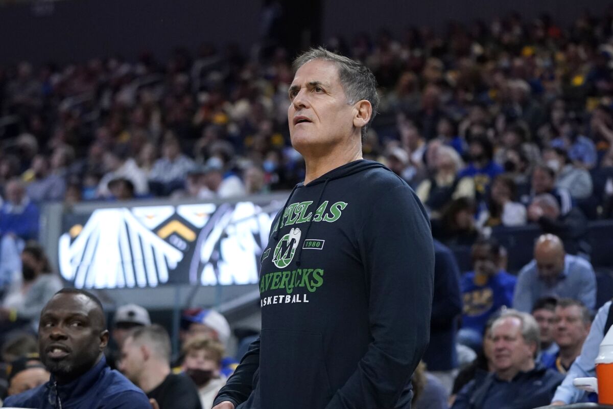 Dallas Mavericks owner Mark Cuban stands behind the bench during the second half of his team's NBA basketball game against the Golden State Warriors in San Francisco, Sunday, Feb. 27, 2022. (AP Photo/Jeff Chiu)