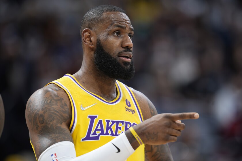 Los Angeles Lakers forward LeBron James gestures to teammates in the first half of an NBA basketball game against the Denver Nuggets Saturday Jan. 15, 2022, in Denver. (AP Photo/David Zalubowski)
