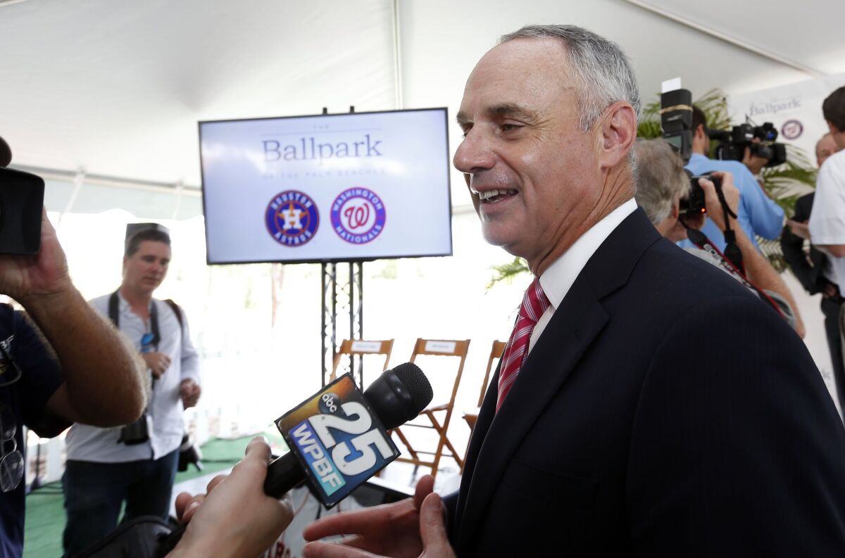 Major League Baseball Commissioner Rob Manfred speaks with reporters Monday in West Palm Beach, Fla.