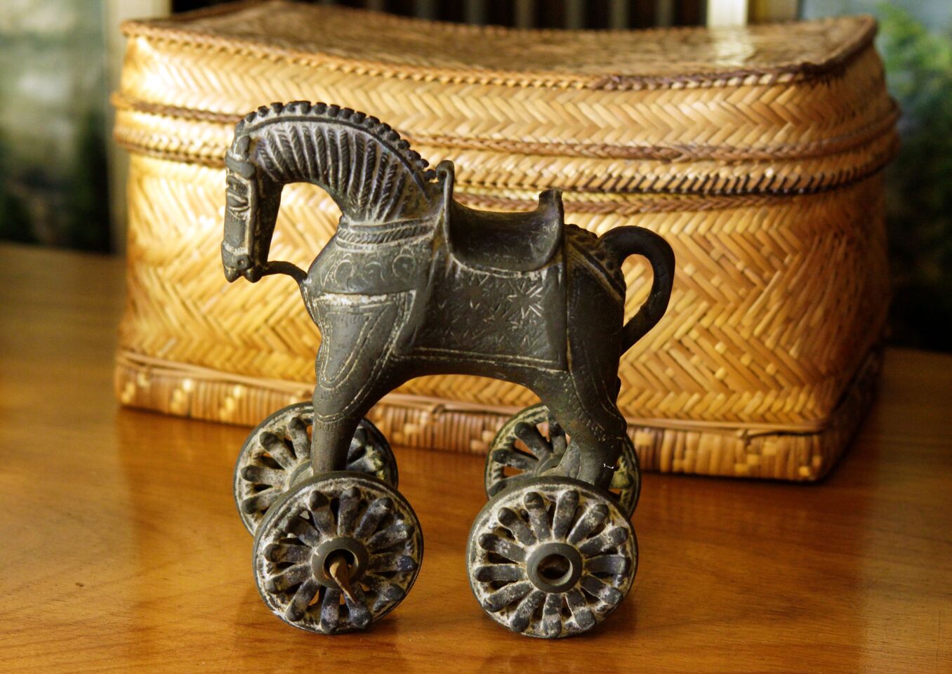 A toy horse on wheels from India and a pillow-shaped basket, possibly from China.