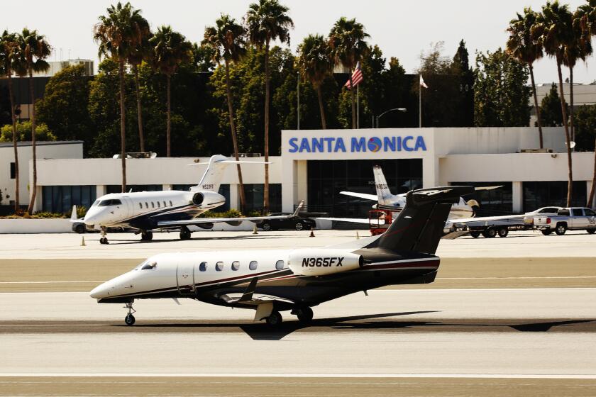 LOS ANGELES, CA AUGUST 31, 2016 -- Jet and small aircraft land and liftoff at Santa Monica Airport on August 31, 2016 as the Federal Aviation Administration has threatened to take legal action against the City of Santa Monica for its effort to close the city airport in 2018. (Al Seib / Los Angeles Times)