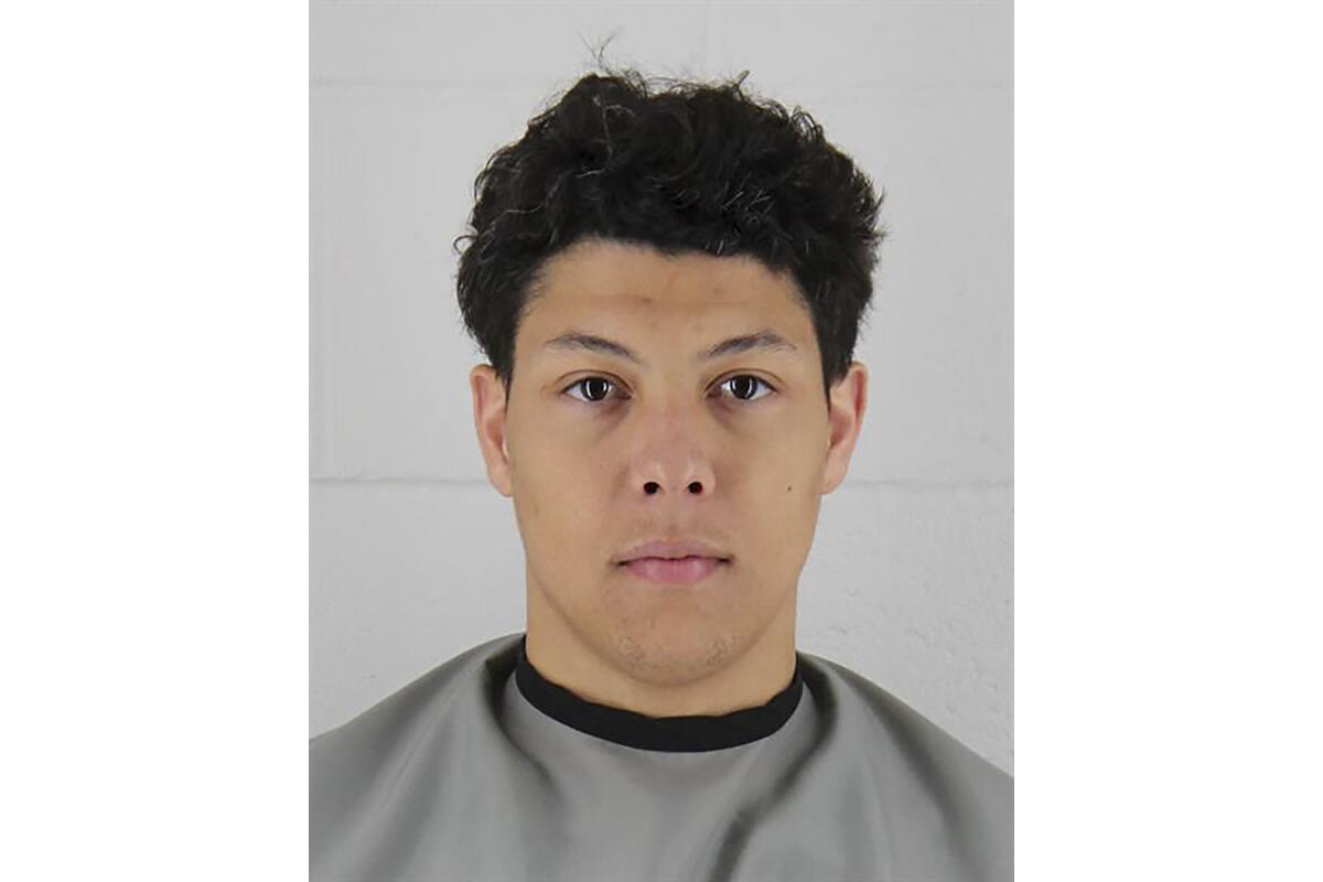 Jackson Mahomes is pictured in a mug shot with a stone-faced expression. 