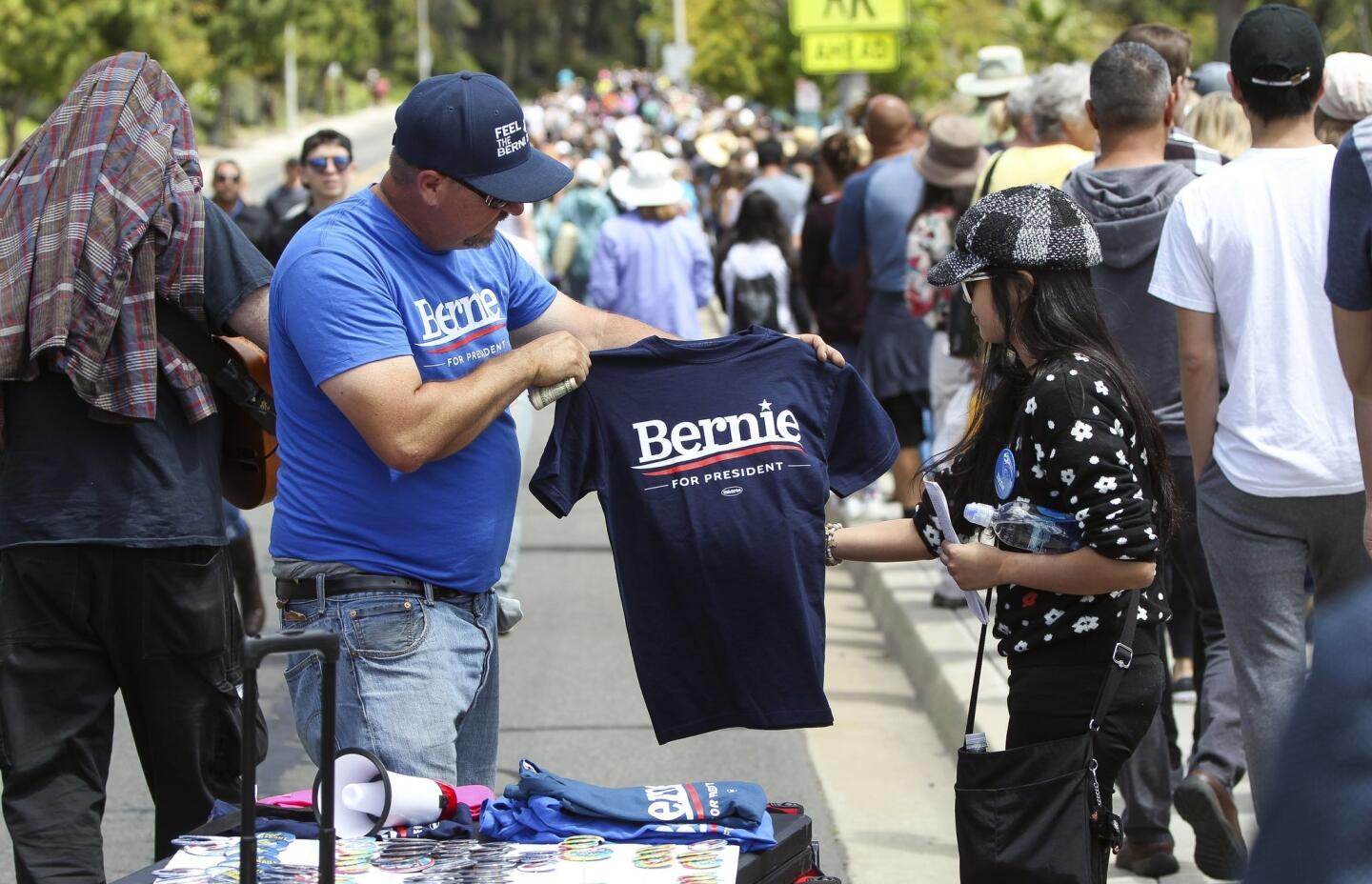 Steve Jones sells Bernie Sanders shirts to people in line to see Democratic presidential candidate Bernie Sanders.