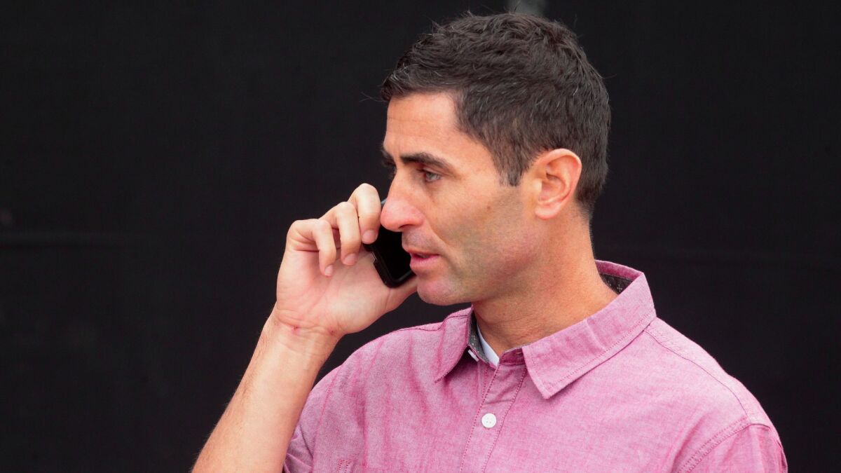 Padres general manager A.J. Preller uses a cell phone on at the Peoria Sports Complex in Peoria, Ariz., on Feb. 18, 2017.